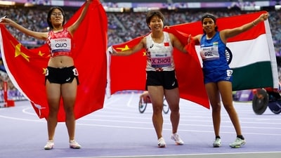 Xia Zhou of China celebrates after winning gold with silver medallist Qianqian Guo of China and bronze medallist Preethi Pal of India (REUTERS)