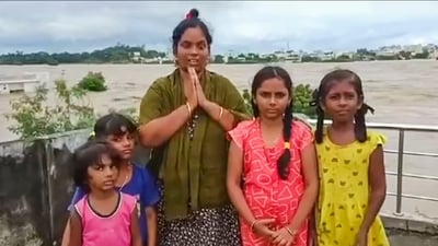 **EDS: SCREENGRAB VIA PTI VIDEOS** Khammam: A woman and children trapped on a rooftop appeal for help amid floods, in Khammam district, Sunday, Sep. 1, 2024. (PTI Photo) (PTI09_01_2024_000183A) (PTI) **EDS: SCREENGRAB VIA PTI VIDEOS** Khammam: A woman and children trapped on a rooftop appeal for help amid floods, in Khammam district, Sunday, Sep. 1, 2024. (PTI Photo) (PTI09_01_2024_000183A) (PTI)
