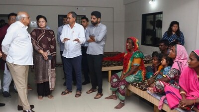Gujarat Chief Minister Bhupendra Patel meets flood-effected people, in Dwarka district. He also spoke with PM Narendra Modi who assured all possible help. (PTI) Gujarat Chief Minister Bhupendra Patel meets flood-effected people, in Dwarka district. He also spoke with PM Narendra Modi who assured all possible help. (PTI)