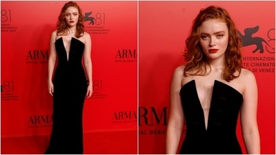 Sadie Sink turned heads at an Armani event at the Venice Film Festival in a Giorgio Armani gown. She wore a strapless black floor-length dress featuring a plunging neckline and a bodycon fitting. She paired the ensemble with siren red lips, loose hair styled in curls, and an emerald ring. (AP) Sadie Sink turned heads at an Armani event at the Venice Film Festival in a Giorgio Armani gown. She wore a strapless black floor-length dress featuring a plunging neckline and a bodycon fitting. She paired the ensemble with siren red lips, loose hair styled in curls, and an emerald ring. (AP)