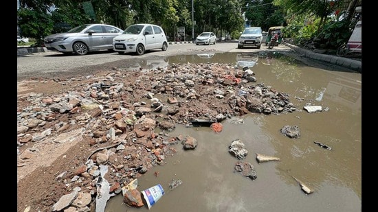 Commuters say potholes on the Lodhi Club Road hinder traffic, lead to frequent accidents. (Gurpreet Singh/HT)