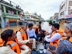Vijayawada: Andhra Pradesh chief minister N Chandrababu Naidu with others during a visit to a flood-affected area. Vijayawada: Andhra Pradesh chief minister N Chandrababu Naidu with others during a visit to a flood-affected area.