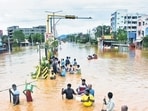 People wade through waterlogged roads in Vijayawada, Andhra Pradesh, on Monday. (Reuters) People wade through waterlogged roads in Vijayawada, Andhra Pradesh, on Monday. (Reuters)