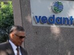 A man walks past the logo of Vedanta outside its headquarters in Mumbai.