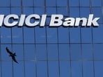 A bird flies past the facade of the ICICI bank head office in Mumbai, India.