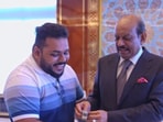 MA Yusuf Ali gifting the fan a watch. 