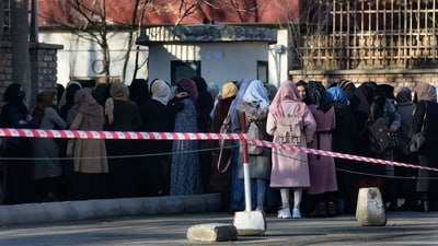 FILE - Afghan students queue at one of Kabul University's gates in Kabul, Afghanistan, on Feb. 26, 2022. Women are banned from private and public universities in Afghanistan with immediate effect and until further notice, a Taliban government spokesman said on, Dec. 20, 2022. (AP Photo/Hussein Malla, File) (AP)