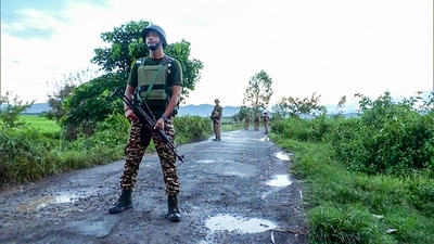 Imphal, Sept 01 (ANI): Security personnel stand guard after a militant attack, at Koutruk in Imphal on Sunday. Reportedly, two people died and six people injured including a Police personnel in the attack. (ANI Photo) (ANI)