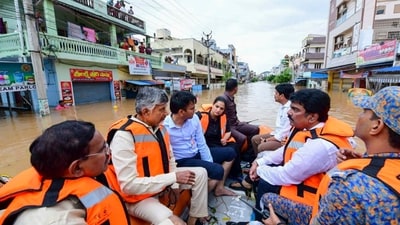 Vijayawada: Andhra Pradesh chief minister N Chandrababu Naidu with others during a visit to a flood-affected area. (PTI) Vijayawada: Andhra Pradesh chief minister N Chandrababu Naidu with others during a visit to a flood-affected area. (PTI)