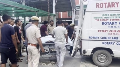 Police personnel shift injured people to a hospital in Imphal on Sunday. (PTI) Police personnel shift injured people to a hospital in Imphal on Sunday. (PTI)