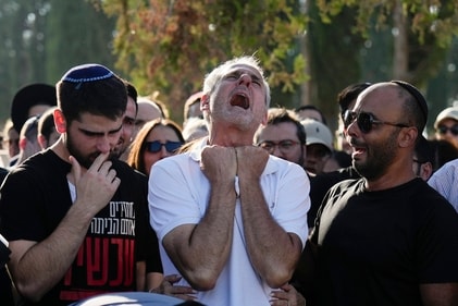 Yigal Sarusi, center, mourns during the funeral of his son, slain hostage Almog Sarusi, who was killed in Hamas captivity in the Gaza Strip, at a cemetery in Ra'anana, Israel, Sunday, Sept. 1, 2024. AP/PTI(AP09_01_2024_000156A) (AP) Yigal Sarusi, center, mourns during the funeral of his son, slain hostage Almog Sarusi, who was killed in Hamas captivity in the Gaza Strip, at a cemetery in Ra'anana, Israel, Sunday, Sept. 1, 2024. AP/PTI(AP09_01_2024_000156A) (AP)