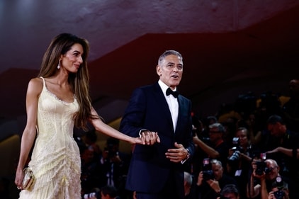 George Clooney and Amal Clooney walk on the red carpet during arrivals for the movie "Wolfs" presented out of competition, during the 81st Venice Film Festival, in Venice, Italy, September 1, 2024. (REUTERS)