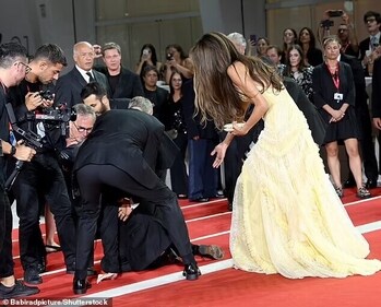 George Clooney assists the photographer. George Clooney assists the photographer.