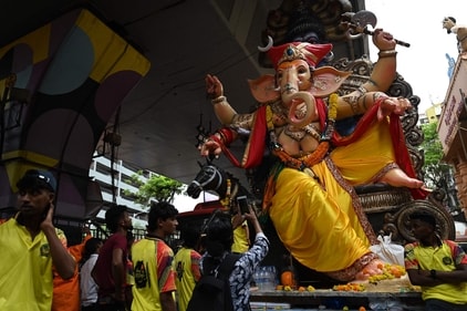 Devotees carry an idol of Lord Ganesh during a procession ahead of the Ganesh Chaturthi festival along a street in Mumbai. (AFP) Devotees carry an idol of Lord Ganesh during a procession ahead of the Ganesh Chaturthi festival along a street in Mumbai. (AFP)