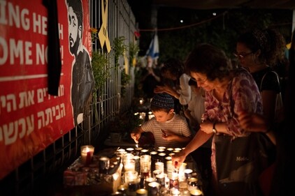 People light candles during a vigil in memory of slain hostage Hersh Goldberg-Polin in Jerusalem, Israel, Sunday, Sept. 1, 2024. (AP Photo/Leo Correa) (AP) People light candles during a vigil in memory of slain hostage Hersh Goldberg-Polin in Jerusalem, Israel, Sunday, Sept. 1, 2024. (AP Photo/Leo Correa) (AP)