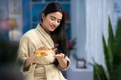 Applying coconut oil helps combat dry scalp and controls frizz. (gettyimages) Applying coconut oil helps combat dry scalp and controls frizz. (gettyimages)