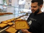 Samir Makari holds a tray of mufataka, a traditional Beiruti sweet, at his shop in the Lebanese capital. A kind of rice pudding made with turmeric, tahini sesame paste, sugar and pine nuts, mufataka is traditional in Beirut but less known even outside the city. 