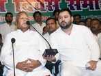 Leader of Opposition Tejashwi Yadav holds a mic while RJD Chief Lalu Prasad addresses party workers during 28th foundation of Rashtriya Janata Dal, at the party office in Patna, Bihar, India, Friday,05, 2024.(Photo by Santosh Kumar/ Hindustan Times)