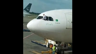 The pilot leaned out of the cockpit to clean the window. (X) The pilot leaned out of the cockpit to clean the window. (X)