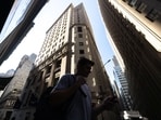 Pedestrians walk along Wall Street near the New York Stock Exchange (NYSE) in New York, US. Pedestrians walk along Wall Street near the New York Stock Exchange (NYSE) in New York, US.