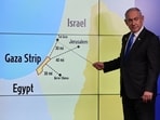 Israeli Prime Minister Benjamin Netanyahu stands before a map showing the Gaza Strip, during a press conference for the international media at the Government Press office in Jerusalem. ABIR SULTAN/Pool via REUTERS