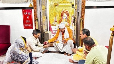 BJP’s state general secretary (organisation) Phanindra Nath Sharma, state general secretary Archana Gupta and Surendra Poonia at the Mata Mansa Devi temple in Panchkula on Wednesday. (HT photo)