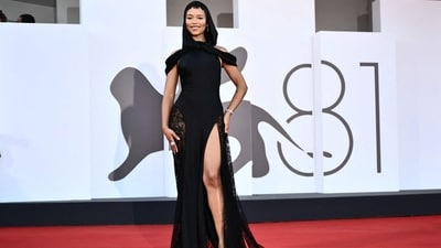 Canadian actress and director Taylor dazzled on the red carpet in a black Loewe gown. The dress, with its eye-catching thigh-high slit, added a touch of flair to her ensemble, making it an absolute showstopper. (Photo by Marco BERTORELLO / AFP)