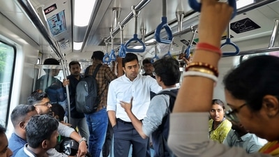 BJP MP Tejasvi Surya interacts with fellow passengers as he rides on a metro train in Bengaluru. (PTI) BJP MP Tejasvi Surya interacts with fellow passengers as he rides on a metro train in Bengaluru. (PTI)