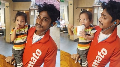 Zomato delivery agent with his daughter at work. Zomato delivery agent with his daughter at work.