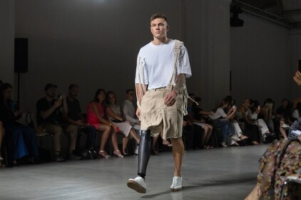 A Ukrainian war veteran wearing prosthetic takes to the runway to demonstrate outfit by designers Andreas Moskin and Andriy Bilous. (AP) A Ukrainian war veteran wearing prosthetic takes to the runway to demonstrate outfit by designers Andreas Moskin and Andriy Bilous. (AP)