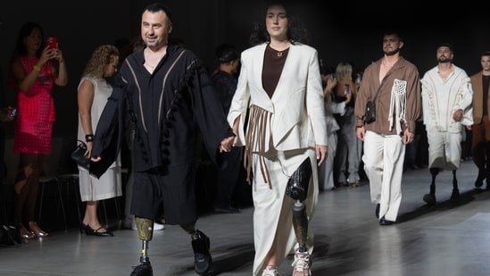 Ukrainian war veterans wearing prosthetics takes to the runway to demonstrate outfit by designers Andreas Moskin and Andriy Bilous during Fashion Week show. (AP)