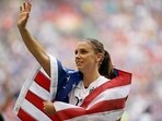 FILE - United States' Alex Morgan is draped in the U.S. flag as she waves to fans after the U.S. beat Japan 5-2 in the FIFA Women's World Cup soccer championship in Vancouver, British Columbia, Canada, Sunday, July 5, 2015. (AP Photo/Elaine Thompson, File) FILE - United States' Alex Morgan is draped in the U.S. flag as she waves to fans after the U.S. beat Japan 5-2 in the FIFA Women's World Cup soccer championship in Vancouver, British Columbia, Canada, Sunday, July 5, 2015. (AP Photo/Elaine Thompson, File)
