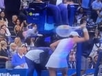 Iga Swiatek smashes her racket in anger.