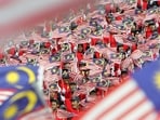 Malaysians wave the national flags during Malaysia Day celebrations in Kuala Lumpur. Malaysians wave the national flags during Malaysia Day celebrations in Kuala Lumpur.