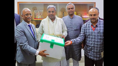 A commission of inquiry headed by Justice Michael D’Cunha submits its inquiry report on Covid irregularities to Karnataka Chief Minister Siddaramaiah. (ANI PHOTO) A commission of inquiry headed by Justice Michael D’Cunha submits its inquiry report on Covid irregularities to Karnataka Chief Minister Siddaramaiah. (ANI PHOTO)