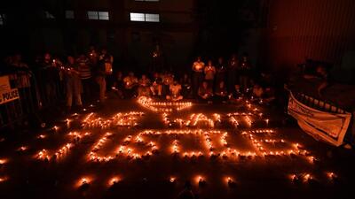 Doctors and health workers light candles at the RG Kar Medical College and Hospital in Kolkata over the alleged rape and murder of a trainee woman doctor inside the hospital premises. (PTI Photo)