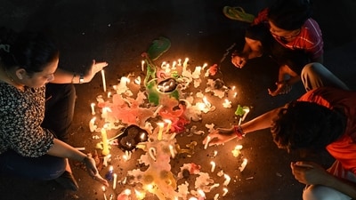 Women were seen lighting candles across the streets of Kolkata. Thousands of women also lit up diyas across Kolkata. (AFP) Women were seen lighting candles across the streets of Kolkata. Thousands of women also lit up diyas across Kolkata. (AFP)