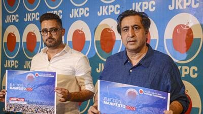 Jammu and Kashmir People's Conference chief Sajad Lone along releases the party manifesto in Srinagar. (PTI)