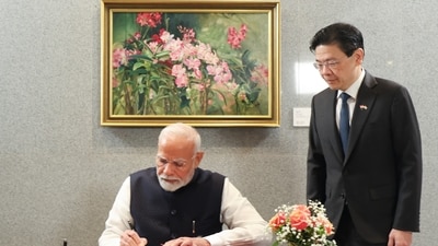 Prime Minister Narendra Modi with his Singapore counterpart Lawrence Wong signs a visitor's book, in Singapore. (PTI) Prime Minister Narendra Modi with his Singapore counterpart Lawrence Wong signs a visitor's book, in Singapore. (PTI)