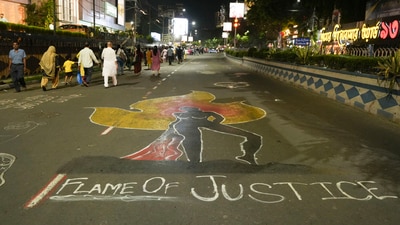 A graffiti is seen on a road amid during candlelight protests against the alleged rape and murder of a trainee woman doctor at the RG Kar Medical College and Hospital, in Kolkata. (PTI) A graffiti is seen on a road amid during candlelight protests against the alleged rape and murder of a trainee woman doctor at the RG Kar Medical College and Hospital, in Kolkata. (PTI)