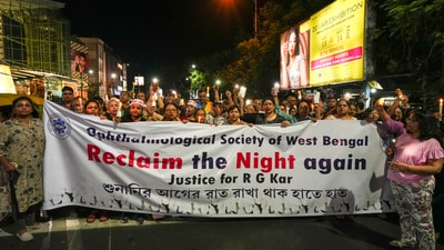 People hold banners during a candlelight march. Reclaim the night march seemed to have returned to the streets of Kolkata for the second time. (PTI) People hold banners during a candlelight march. Reclaim the night march seemed to have returned to the streets of Kolkata for the second time. (PTI)
