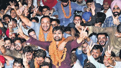 Panjab University student body president  Anurag Dalal with Sikandar Boora, the former Chandigarh president of NSUI, and other supporters on campus on Thursday. (Ravi Kumar/HT)