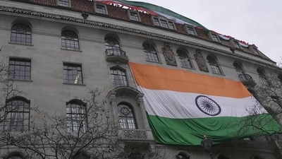 People show an Indian flag from the roof of the Indian High Commission as protestors of the Khalistan movement demonstrate on the streets in London on March 22, 2022. (AP file) People show an Indian flag from the roof of the Indian High Commission as protestors of the Khalistan movement demonstrate on the streets in London on March 22, 2022. (AP file)