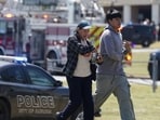 People walk as law enforcement officers work at the scene of a shooting at Apalachee High School in Winder, Georgia, U.S. September 4, 2024. REUTERS/Elijah Nouvelage