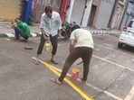 MCD workers mark parking lots under the new system. (HT Photo)