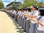 School students take part in a human chain rally to protest against the recent drone and gun attacks in Manipur's Koutruk and Senjam Chirang that resulted in two civilian deaths and 12 injuries. School students take part in a human chain rally to protest against the recent drone and gun attacks in Manipur's Koutruk and Senjam Chirang that resulted in two civilian deaths and 12 injuries.