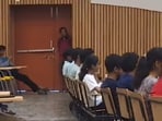 A viral video from IIT Kanpur shows a student sneaking into class late, sparking laughter as the professor jokingly probes the situation. 
