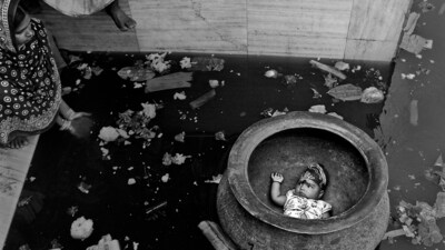 Chhele bhasan' : In a small circular pond adjacent to the Ghutiyari Sharif Mazar near Kolkata children are let afloat in huge cauldrons. Parents from near and far come with the belief that in doing so they would be putting their child into the care of the resident saint. People on the bank use their hands to create a circular current in the water. The child soon completes its maiden voyage, amused or crying its lungs out; the parents gather it and go home: assured that the spirit of the holy man will forever continue to look out for the child. ( Photo by Sandipan Mukherjee) Chhele bhasan' : In a small circular pond adjacent to the Ghutiyari Sharif Mazar near Kolkata children are let afloat in huge cauldrons. Parents from near and far come with the belief that in doing so they would be putting their child into the care of the resident saint. People on the bank use their hands to create a circular current in the water. The child soon completes its maiden voyage, amused or crying its lungs out; the parents gather it and go home: assured that the spirit of the holy man will forever continue to look out for the child. ( Photo by Sandipan Mukherjee)