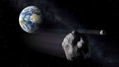 In this artistic rendering, two asteroids fly past Earth. (AP) In this artistic rendering, two asteroids fly past Earth. (AP)