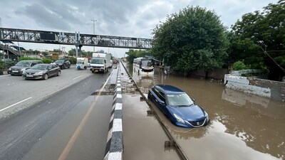 A car and bus are stranded in waterlogged conditions on NH-48 at Narsinghpur Village in Gurugram, highlighting the severe impact of the rain. (Parveen Kumar/HT Photo) A car and bus are stranded in waterlogged conditions on NH-48 at Narsinghpur Village in Gurugram, highlighting the severe impact of the rain. (Parveen Kumar/HT Photo)